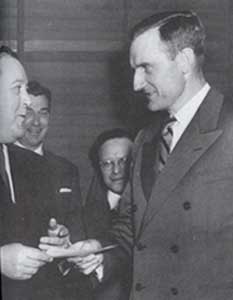John D. Rockefeller, III, (right) presents a check in the amount of $8,5000,000 to Trygve Lie, First Secretary General of the United Nations. The money is to purchase the land on Manhattan Island which will house the U.N. building.